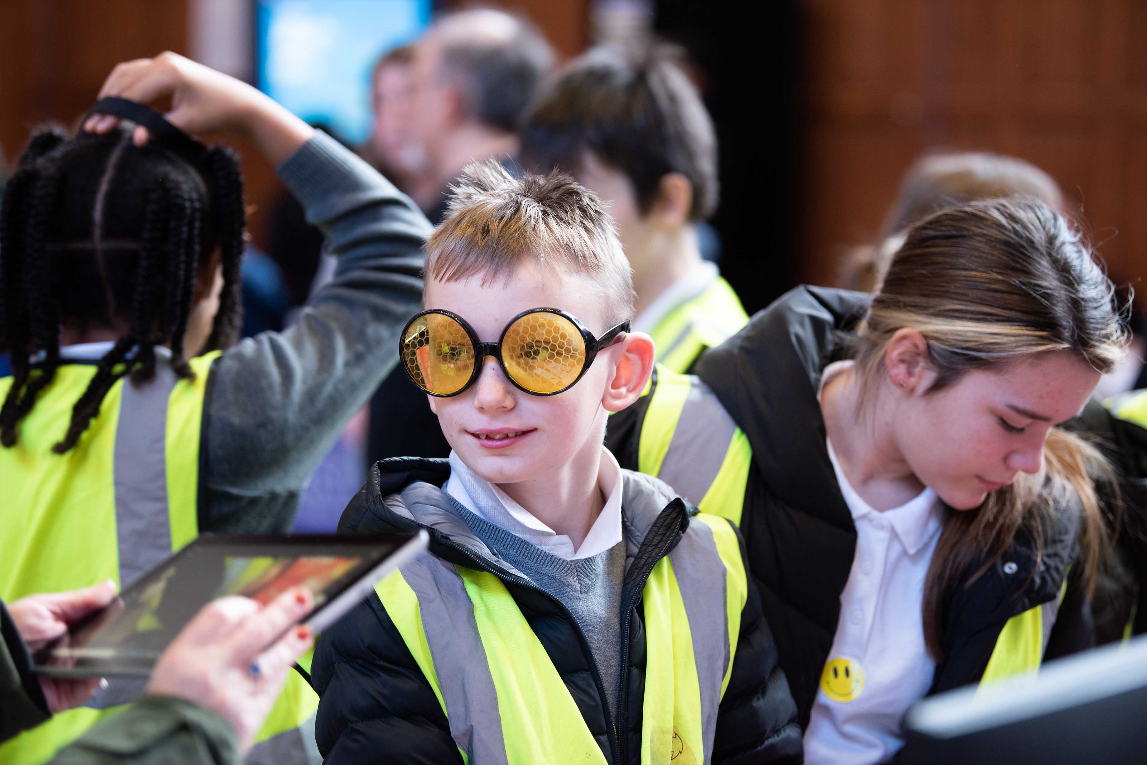 Pupil wearing yellow-lenses glasses